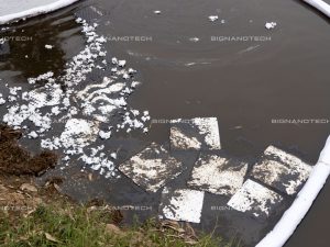 Oil Absorbent Cotton cleaning an oil spill in a sensitive river ecosystem