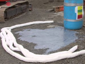 Oil absorbent boom forms a circular barrier around the spill site