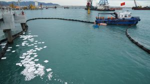 Oil Absorbent pad N-Fiber floating on a river, tackling oil spills 